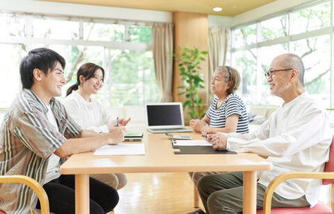 Young couple speaking to retired parents about reverse mortgages