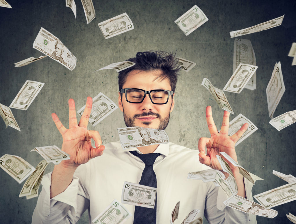 man with a positive financial mindset surrounded by money