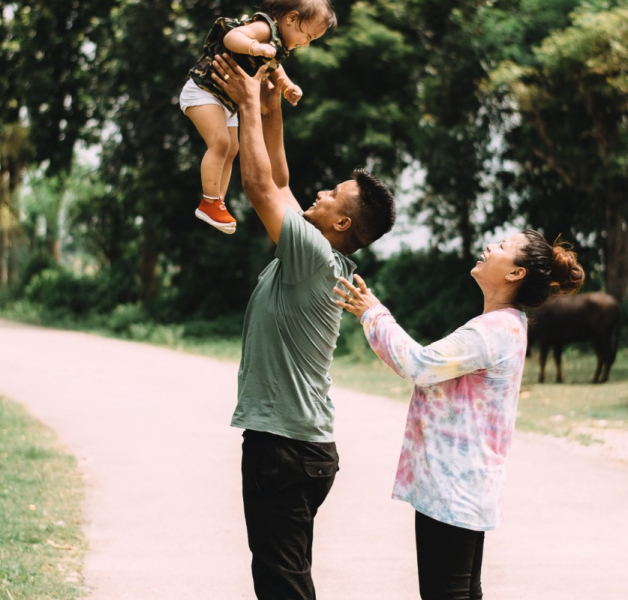 man and woman playing with child