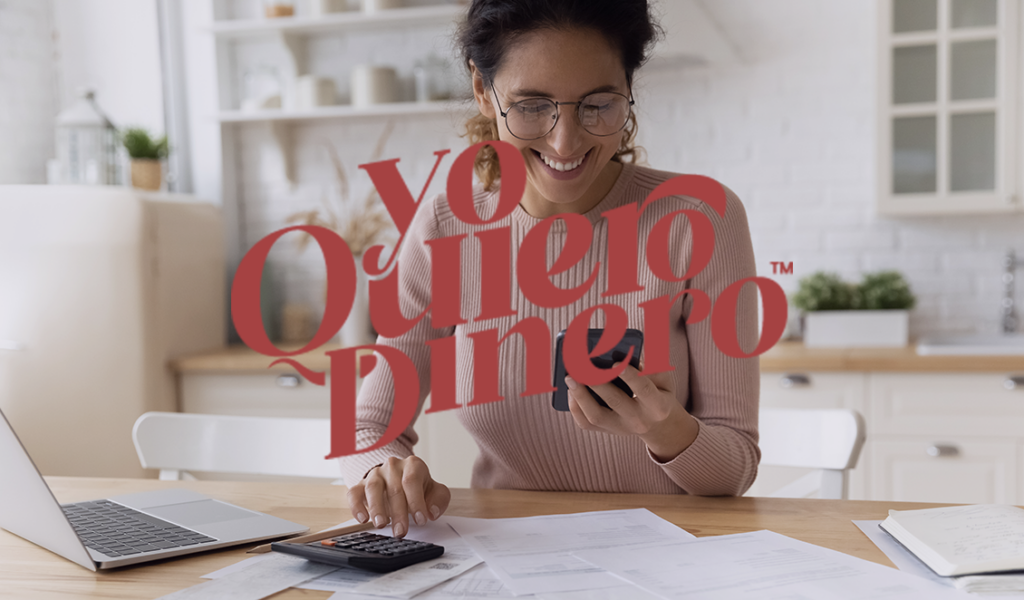 Cover art for the Yo Quiero Dinero podcast. A woman using a calculator while seated in front of a laptop, focused on financial tasks.