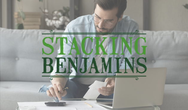 Cover art for the Stacking Benjamins podcast. A picture of a man seated in front of a laptop doing financial calculations.