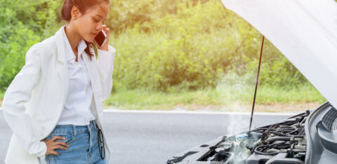 woman stranded on road with car troubles
