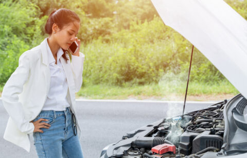 woman stranded on road with car troubles
