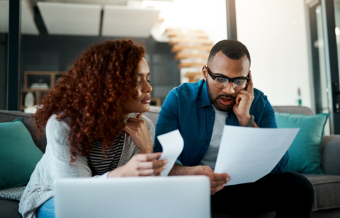 Man looking at bill with wife