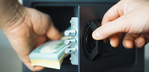 putting money away in a safe