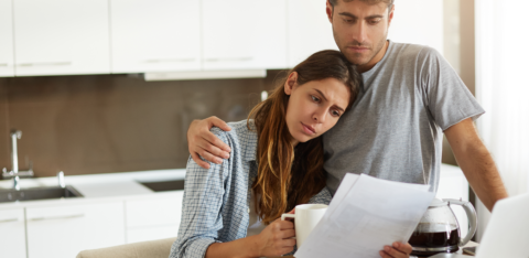 concerned couple looking at bills