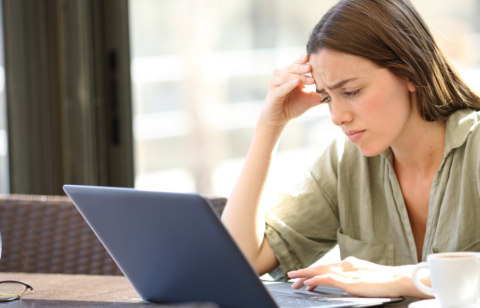 concerned woman looking at computer