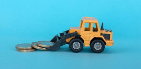 Miniature construction vehicle moving coins