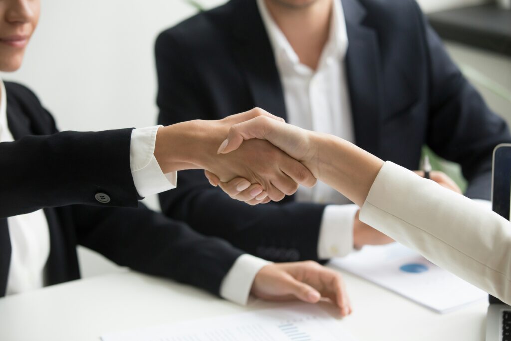 Close-up of a professional handshake between two people in business attire