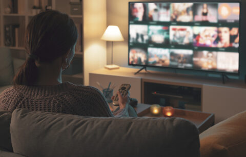 Woman looking at streaming options on tv