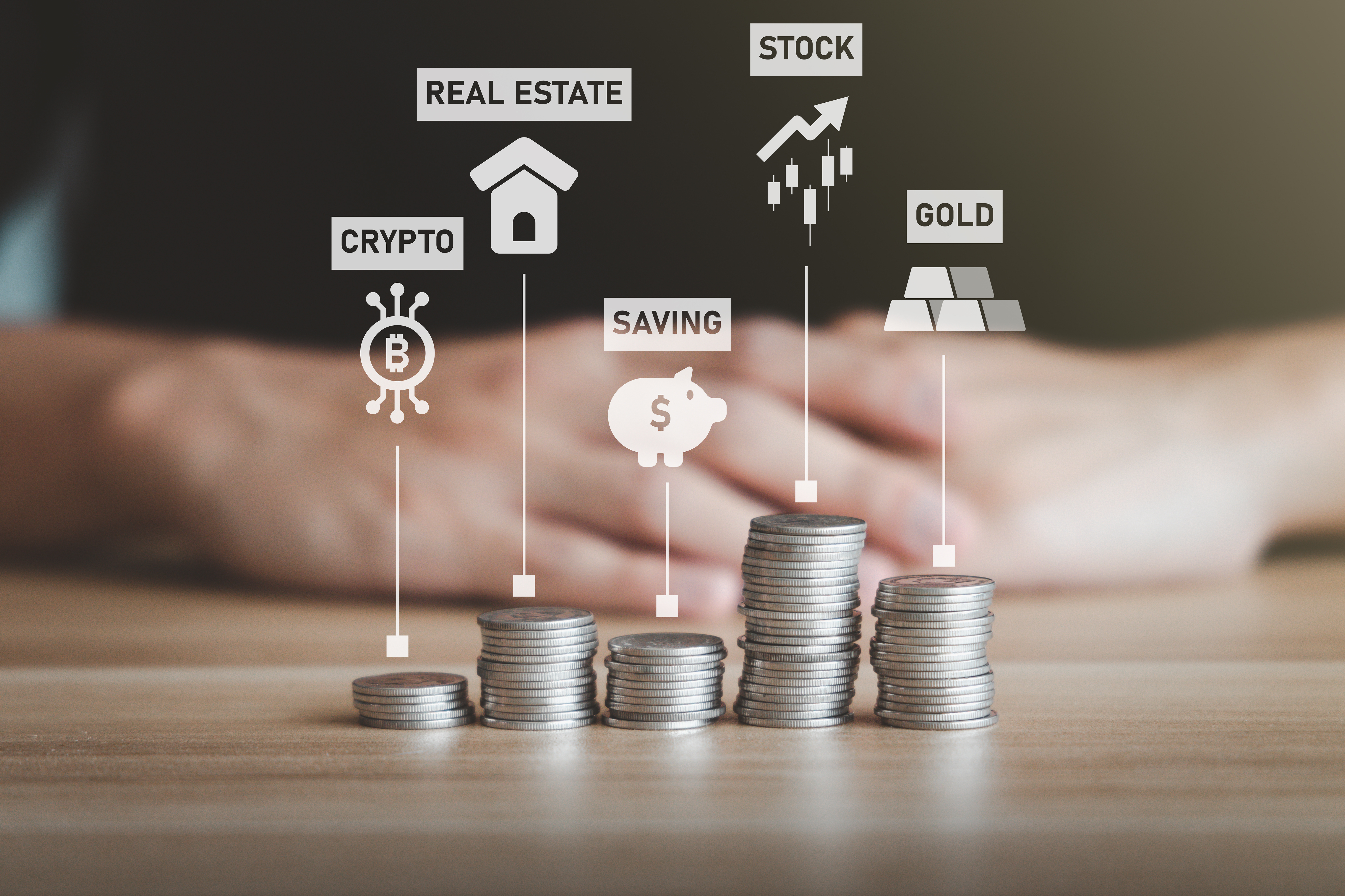 Stacks of coins representing different investment types, including crypto, real estate, savings, stocks, and gold.