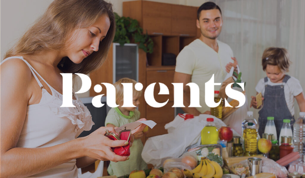 A mother checking a receipt while her family unpacks groceries in the kitchen, with the Parents logo overlayed on the image.