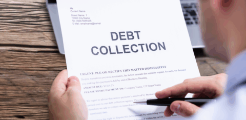 Person holding a debt collection notice with the words “Debt Collection” printed in large letters at the top.