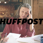 Older adult woman reviewing financial documents at home, appearing worried as she looks over papers next to an open laptop, with a HuffPost logo over the image.