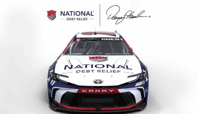Front view of a National Debt Relief–branded NASCAR race car with red, white, and blue design elements.