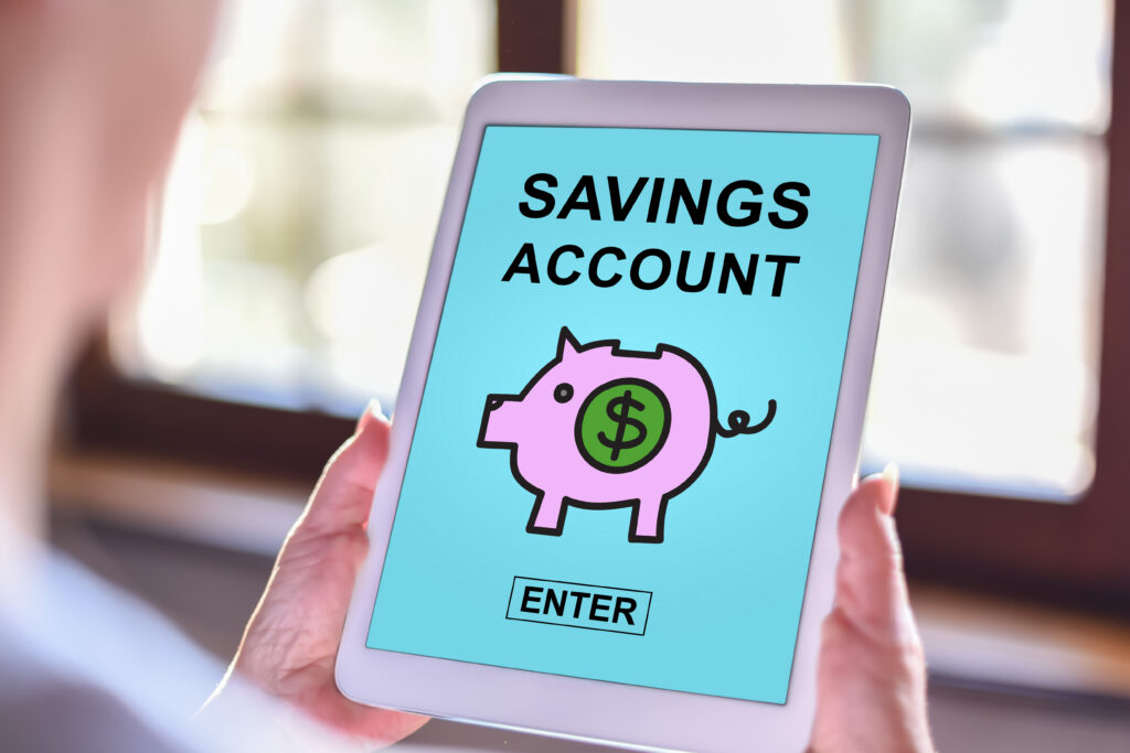 Tablet screen displaying “Savings Account” with a piggy bank icon and enter button.