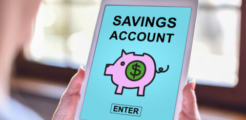Tablet screen displaying “Savings Account” with a piggy bank icon and enter button.