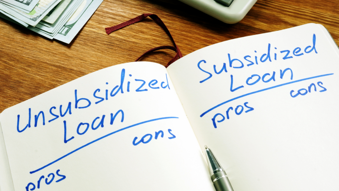 Notebook comparing unsubsidized and subsidized loans with pros and cons, next to cash and a calculator