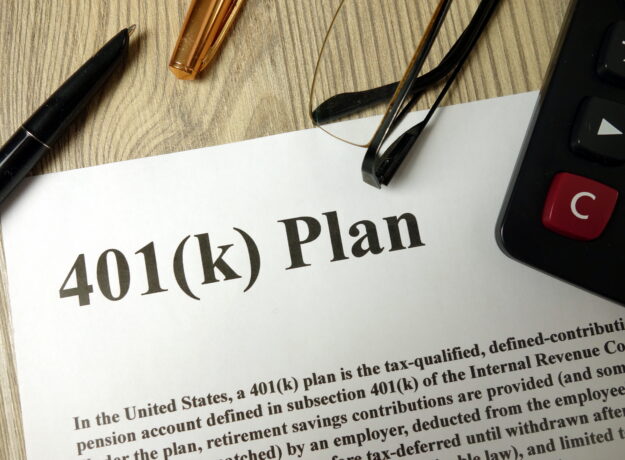 Document labeled “401(k) Plan” on a desk with a pen, eyeglasses, and calculator nearby.