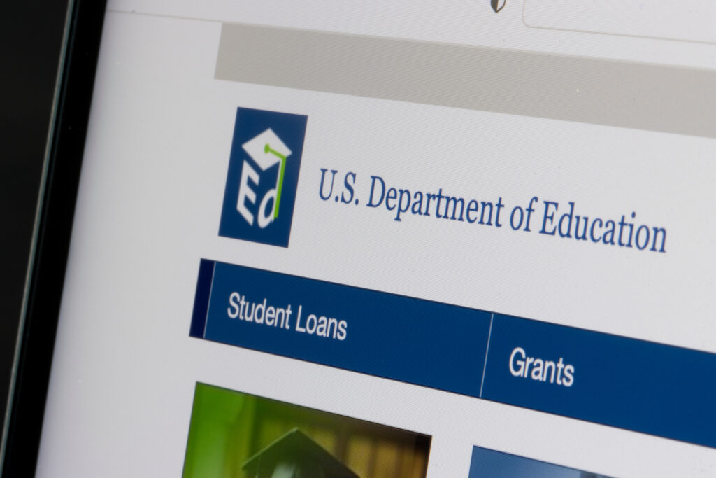 Close-up of the U.S. Department of Education website showing navigation for student loans and grants